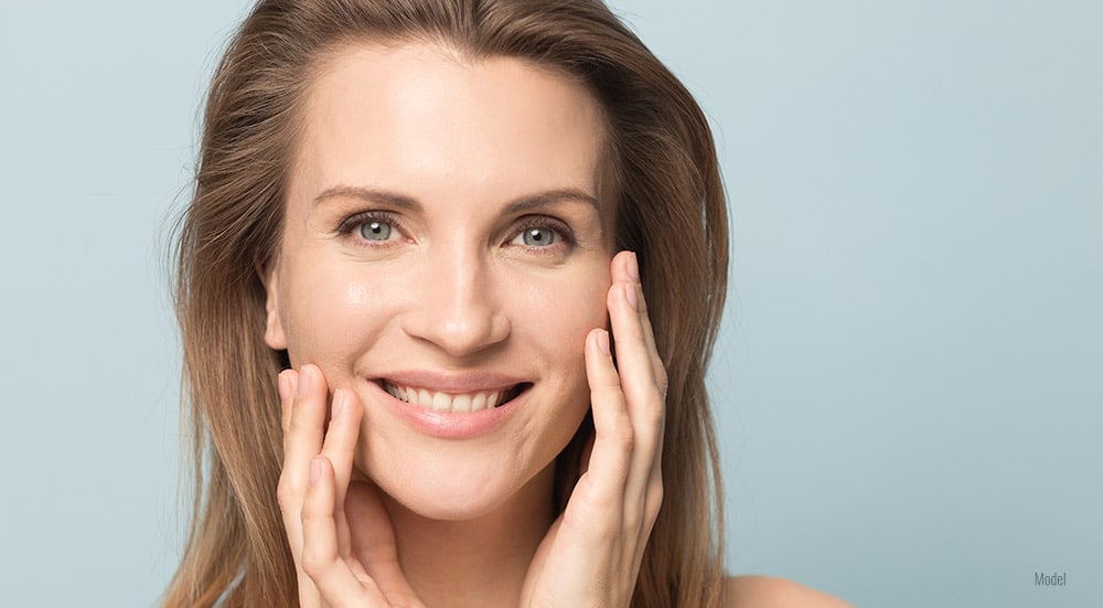 Women touching her face with both hands