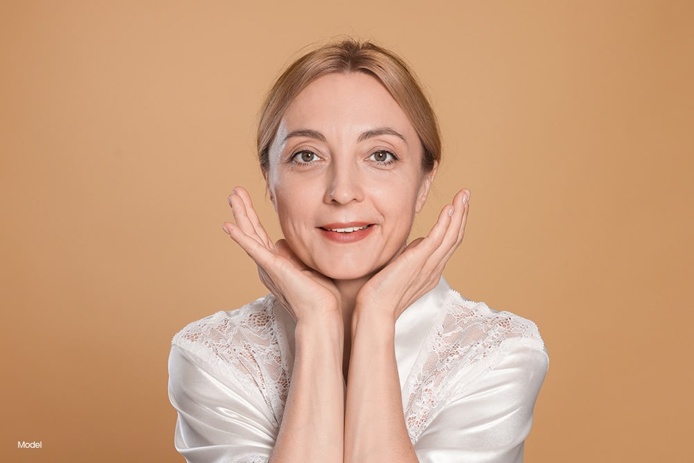 Mature woman touching her face