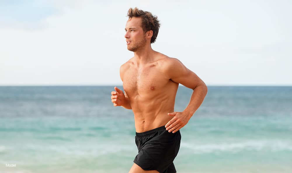 Fit man running at the beach